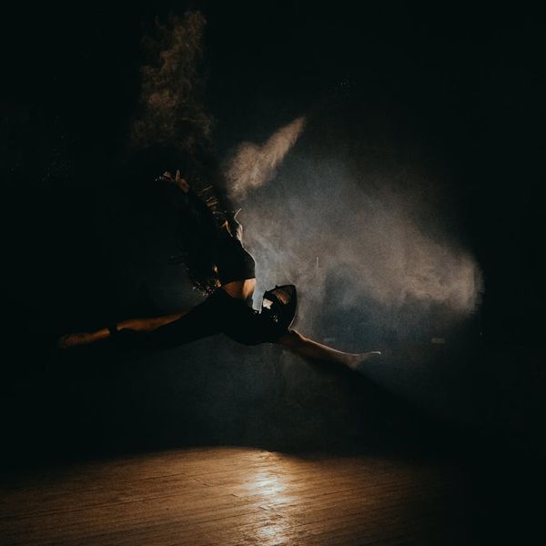 Woman performing a fluid, low-intensity cardio movement in a calm studio environment.